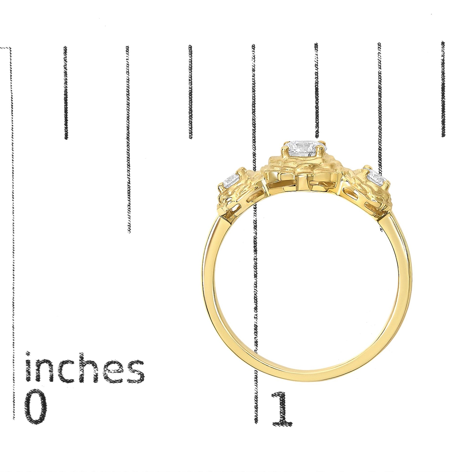 Close-up side angle of a yellow metal ring with three round white gemstones in prong settings, shown on a measurement scale.