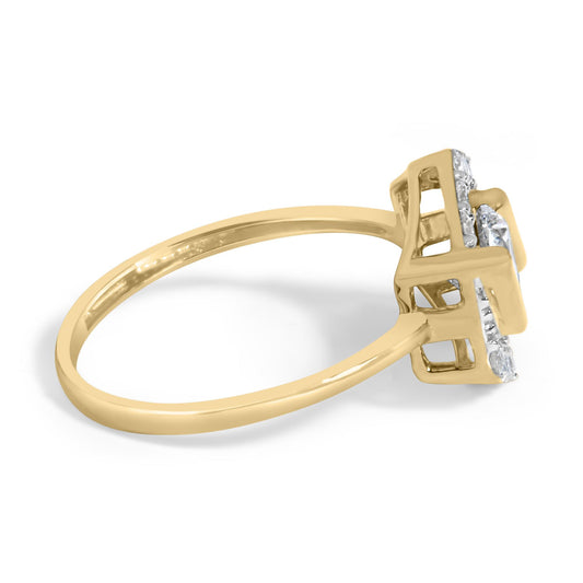 Close-up side angle of a yellow metal ring featuring round white gemstones in prong settings, including one prominent gemstone above a cluster of smaller ones.