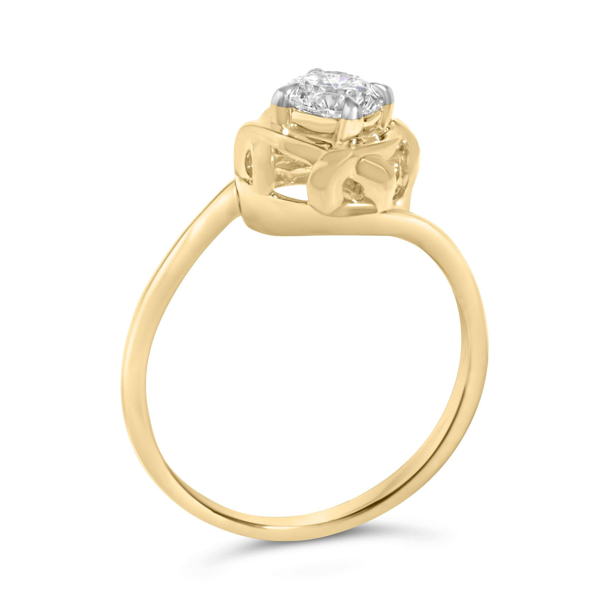 Yellow metal ring with a round white gemstone in prong setting, shown from a side angle.