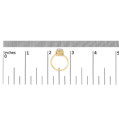 Yellow ring with a round white gemstone in prong setting, shown on a scale, front view.