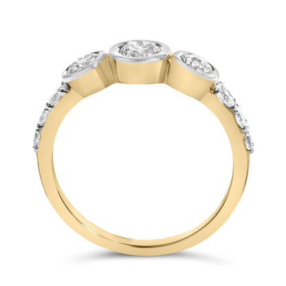 Close-up front angle of a yellow metal ring featuring multiple round white gemstones in prong and bezel settings along the top and sides.