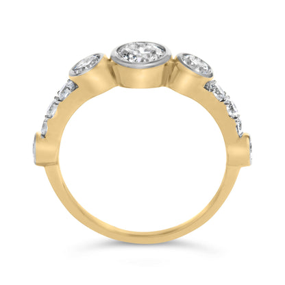 Close-up front angle of a yellow metal ring featuring a central round bezel-set white gemstone flanked by two round bezel-set white gemstones, with additional round prong-set white gemstones along the band.