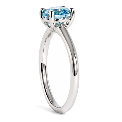 Side view of IGI certified 14K white gold solitaire ring with a round lab-grown blue fancy vivid diamond on white