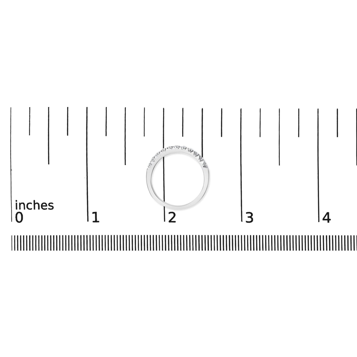 White metal ring with a row of small round white gemstones in a micro-pave setting, shown flat on a ruler scale, top-down angle.