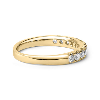 Yellow band ring with a row of round white gemstones in micro-pave setting, shown in a close-up angled side view.