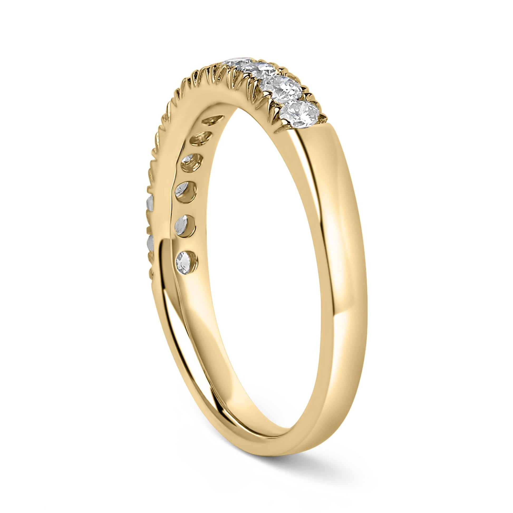 Yellow metal ring with a row of round white gemstones in a micro-pave setting, shown at a slight angle.