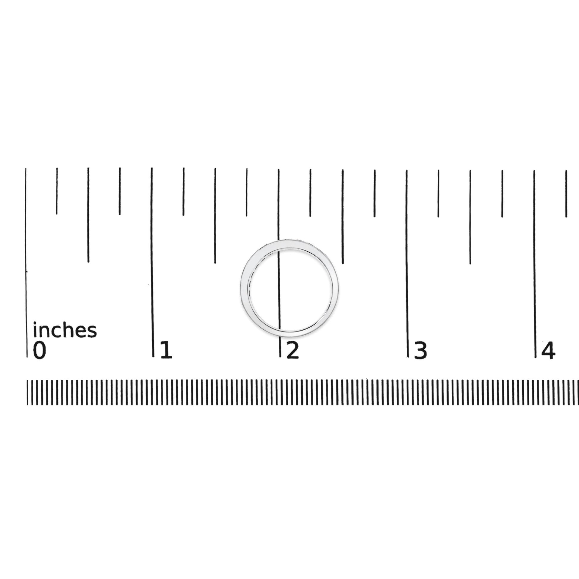 White metal ring with round white gemstones in a channel setting, shown on a scale from a top-down angle.