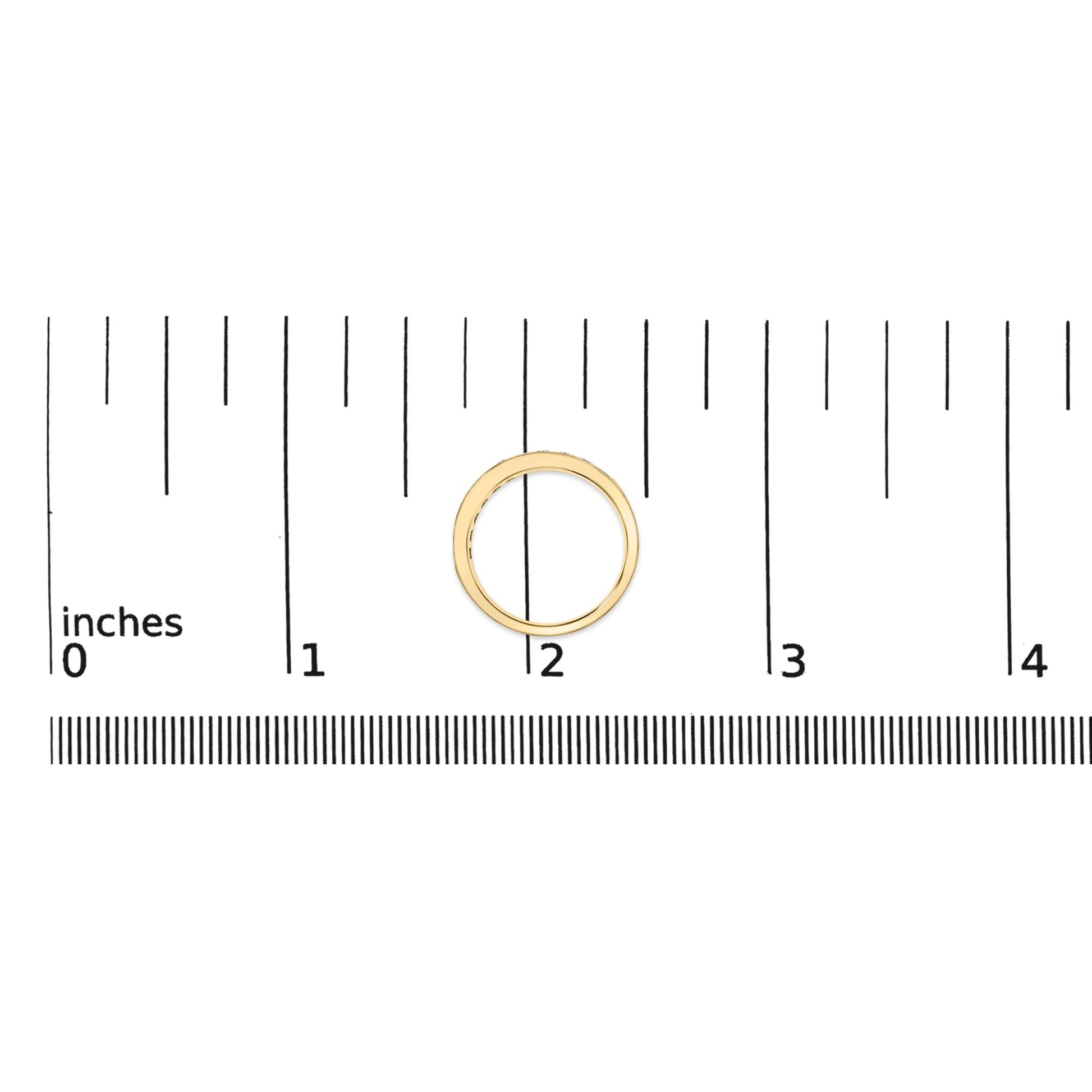 Yellow metal ring with round white gemstones set in a channel setting, shown on a scale from a top-down angle.