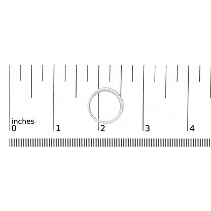 White metal ring with a micro-pave setting of round white gemstones shown on a ruler scale, top-down angle.