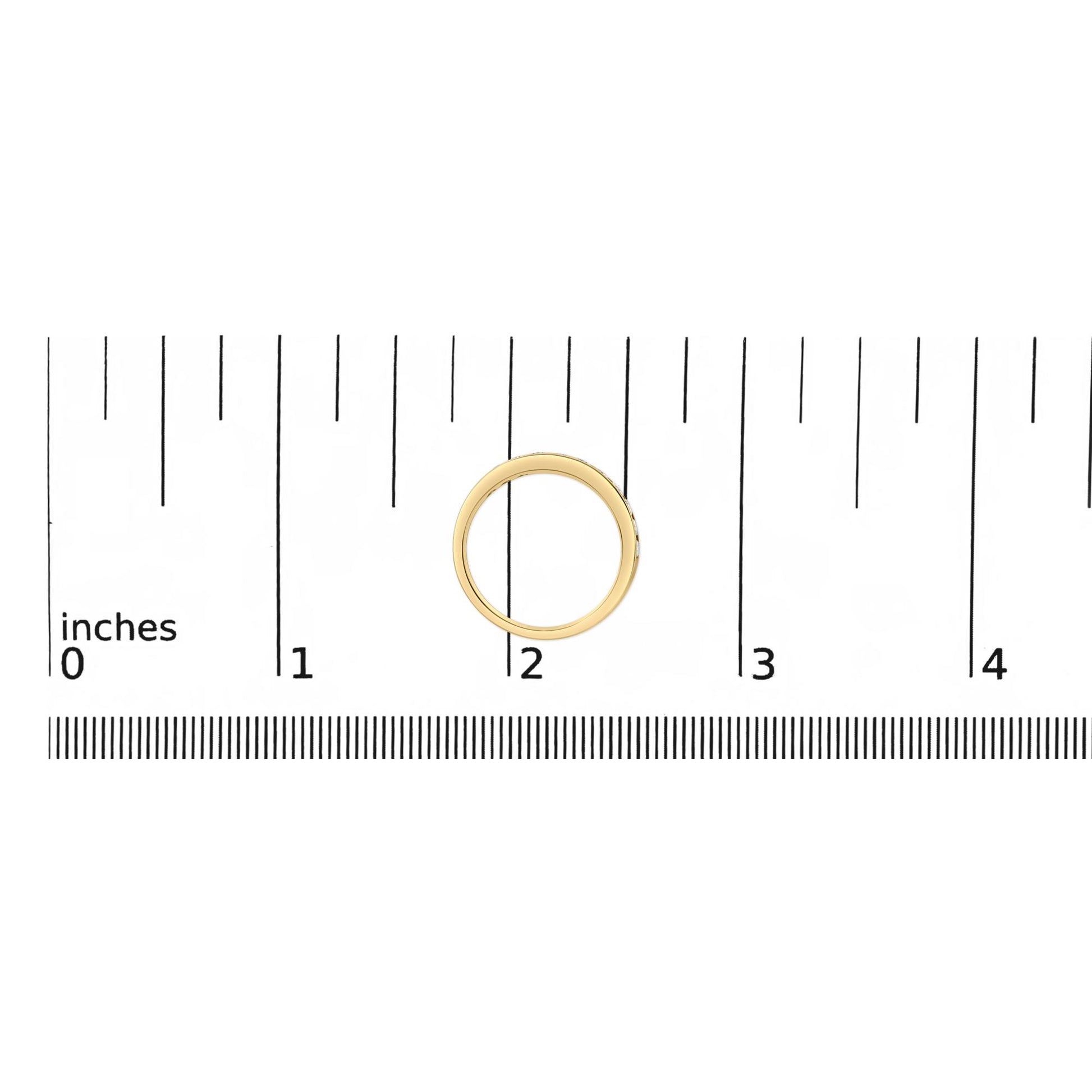 Yellow metal ring with round white gemstones in micro-pave setting, shown on a scale from a top-down angle.