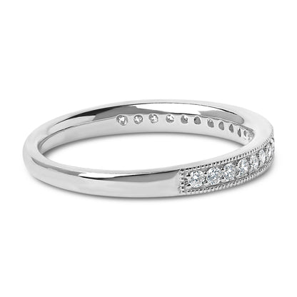 Close-up angled view of a white metal ring with a section featuring white round gemstones in a micro-pave setting.