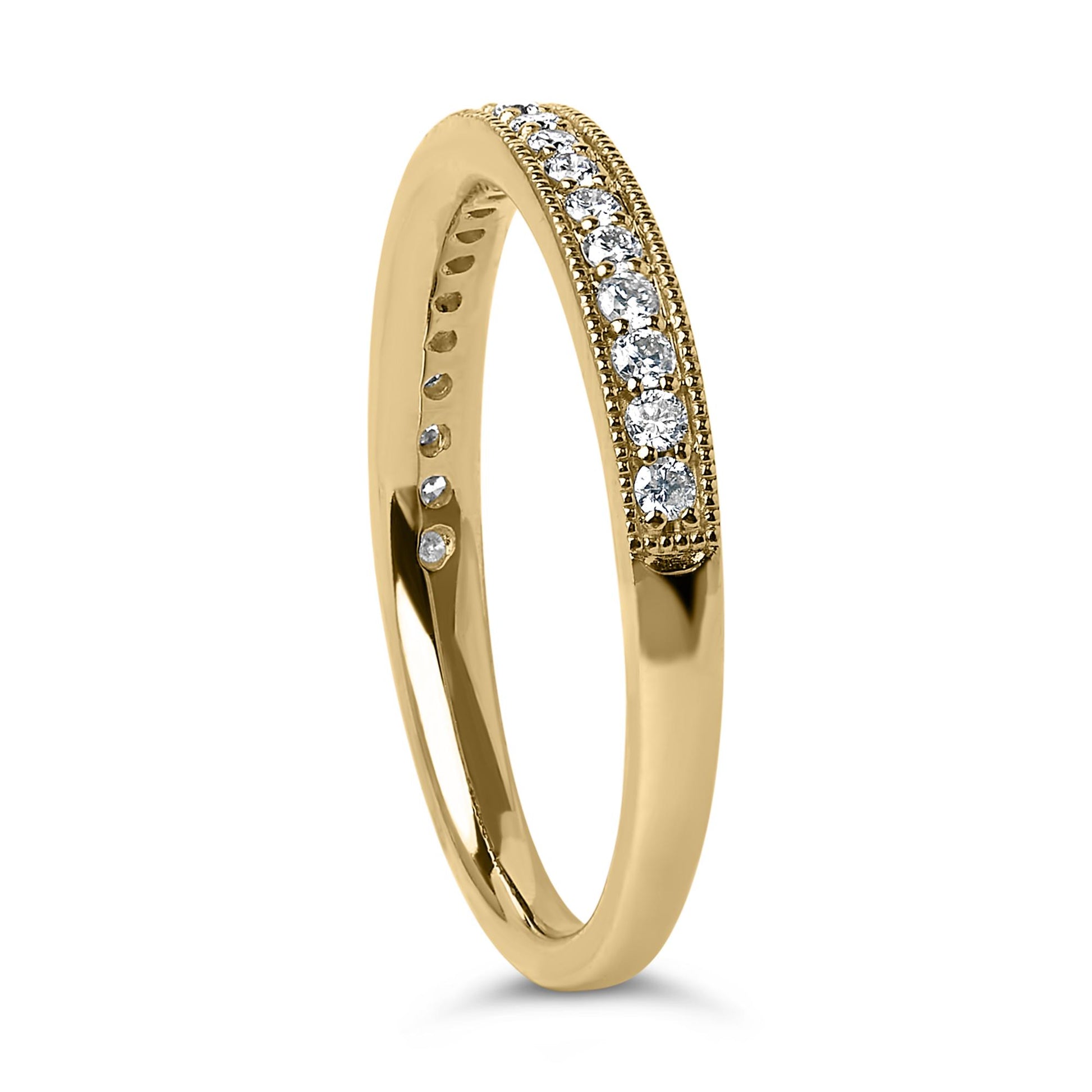 Yellow metal ring with a row of round white gemstones set in a micro-pave design, shown from a front angled view.
