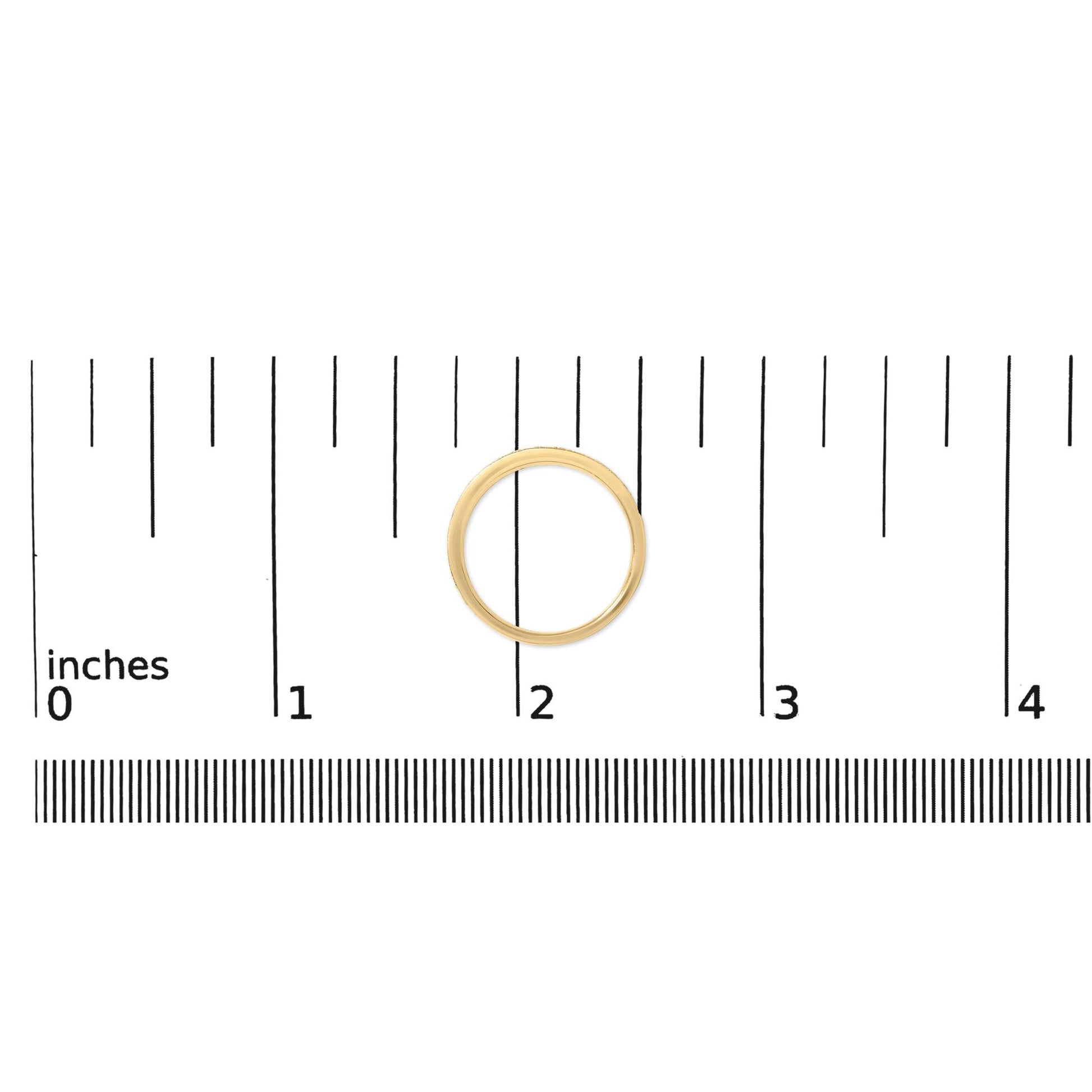 Top-down view of a yellow metal ring with a band partially set with round white gemstones in a micro-pave setting, shown on a measurement scale.