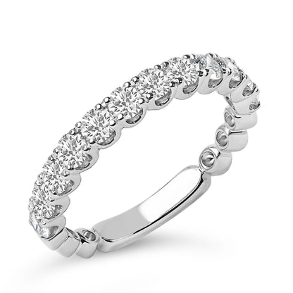 Close-up angled image of a white metal ring featuring a continuous row of round white gemstones in 4-prong settings around the band.