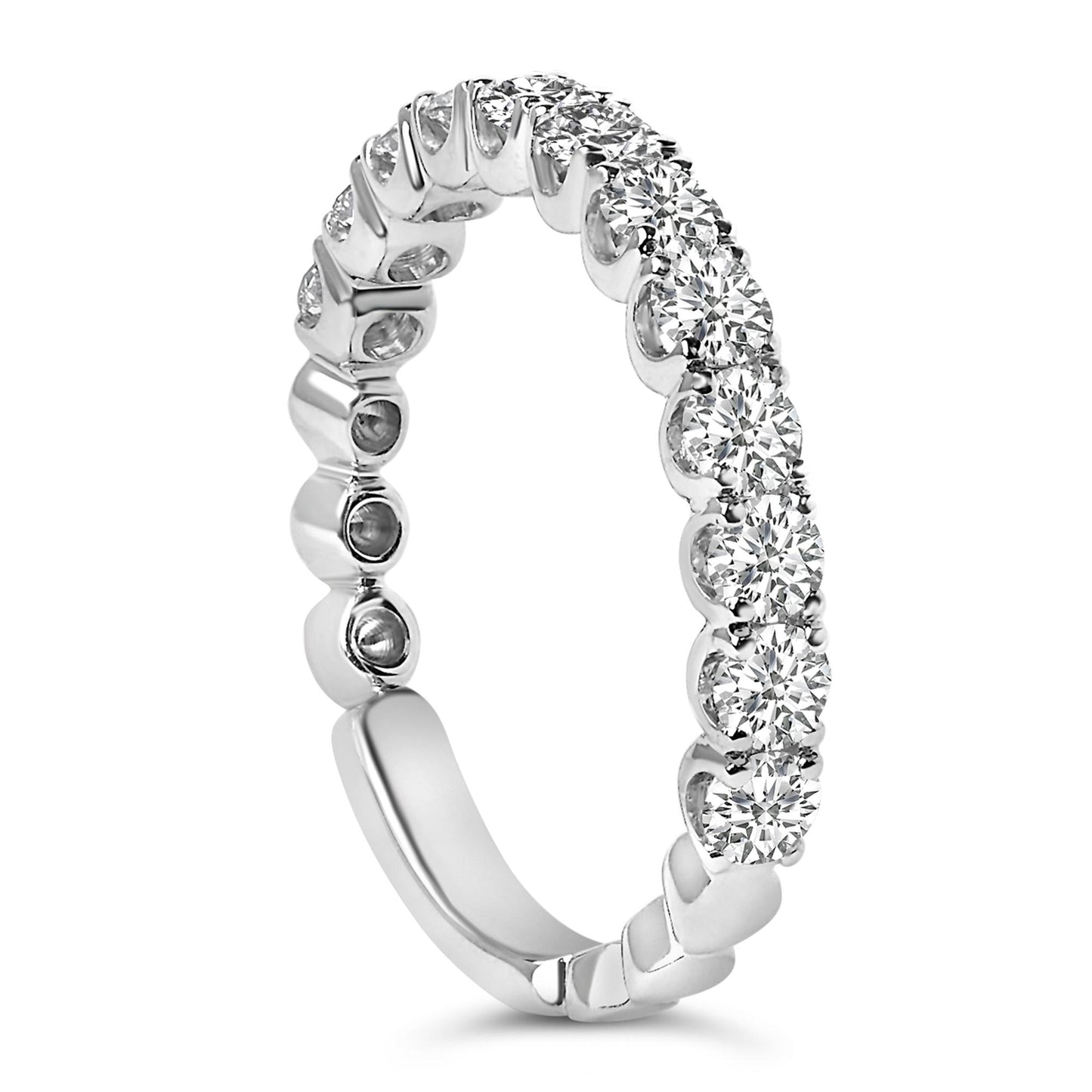 Close-up side angle of a white metal ring featuring a continuous row of round white gemstones in 4-prong settings around the band.