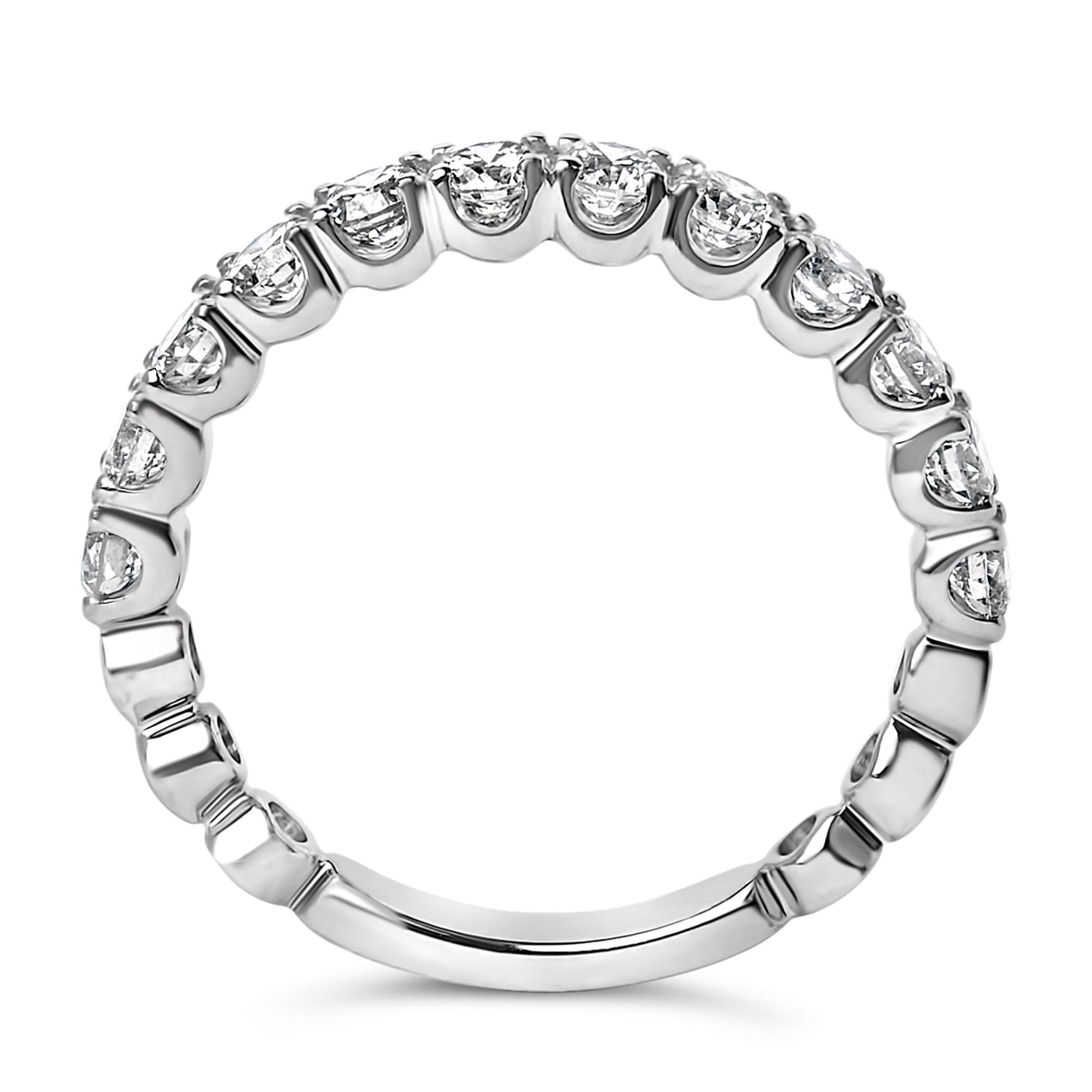 White metal ring with a continuous row of round white gemstones in 4-prong settings, shown in a close-up front-facing angle.