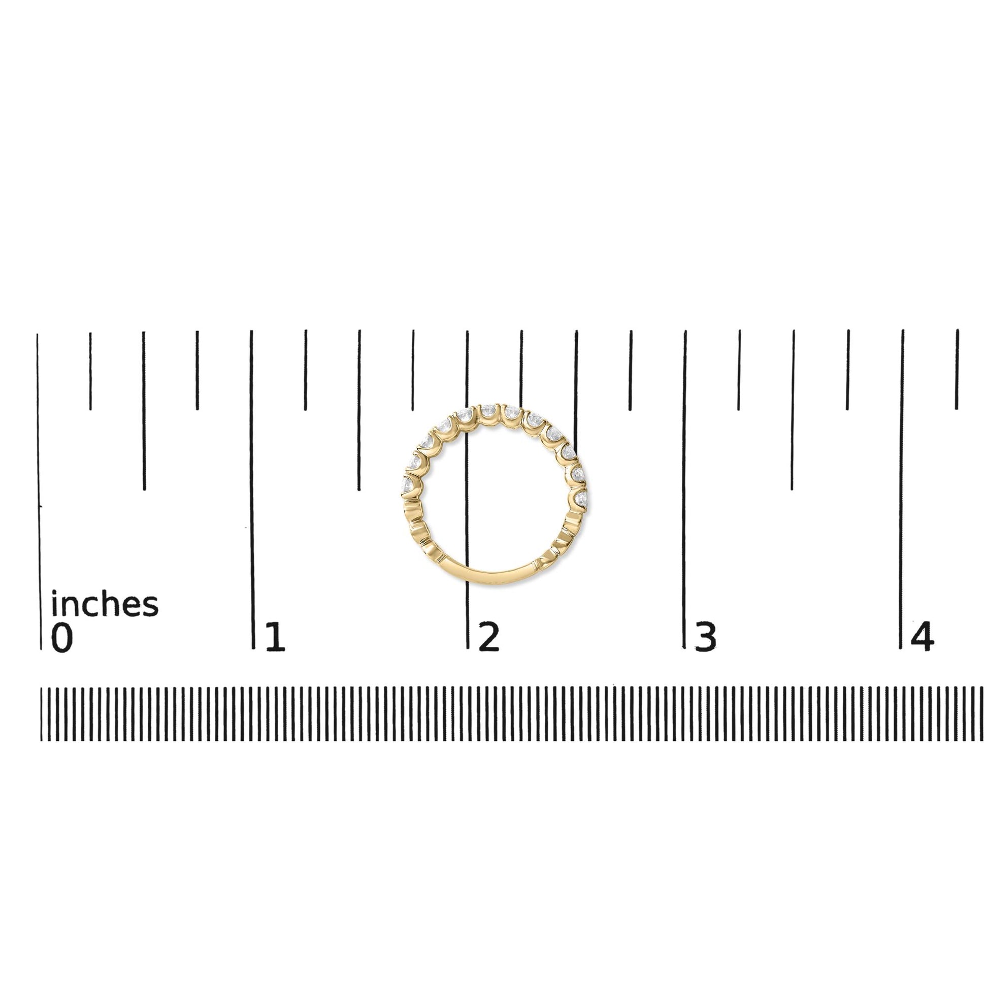 Yellow metal ring with round white gemstones in 4-prong settings, shown on a scale from a top-down angle.