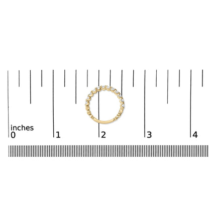 Yellow metal ring with round white gemstones in 4-prong settings, shown on a scale from a top-down angle.