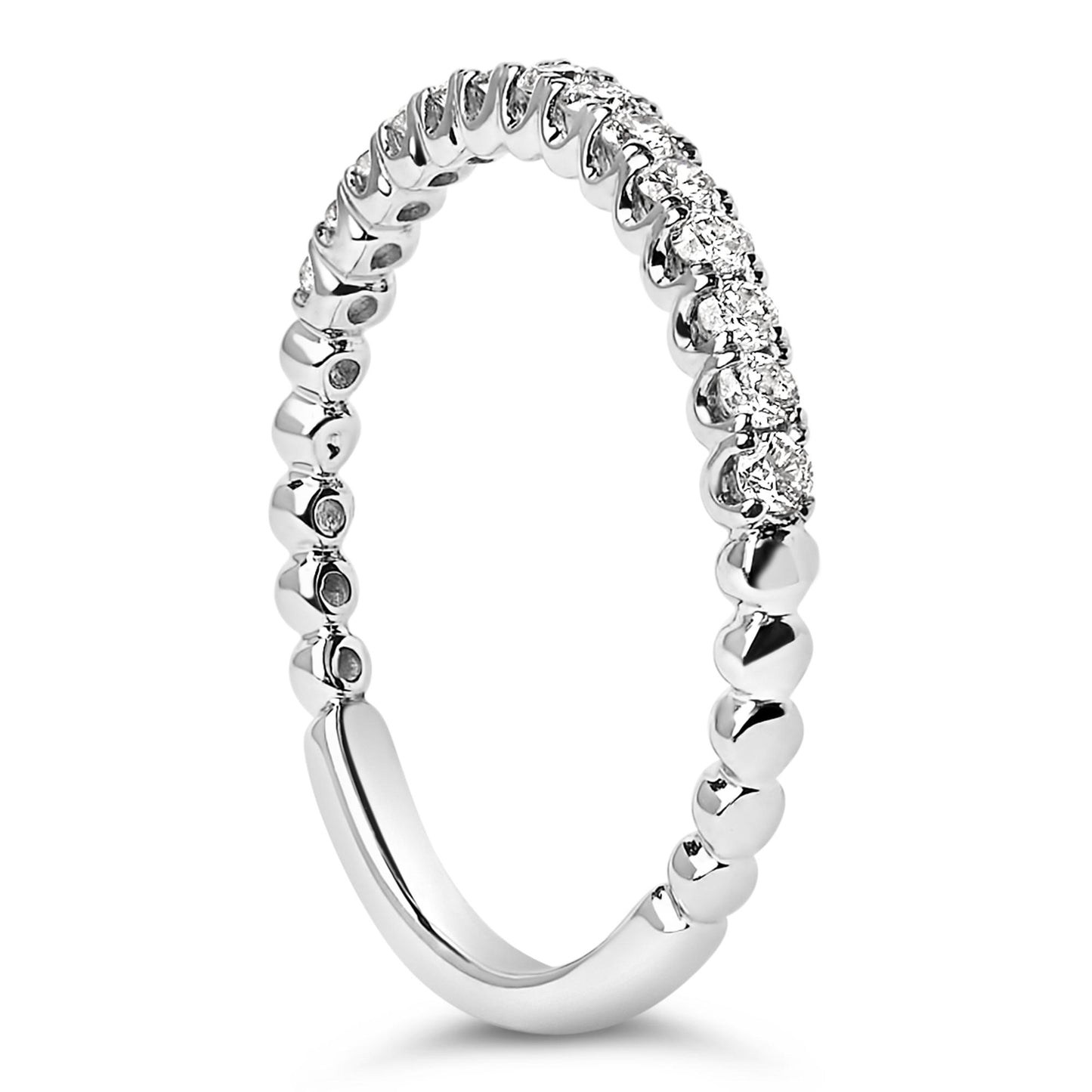 Close-up angled view of a white metal ring featuring round white gemstones in a prong setting along the top half of the band.