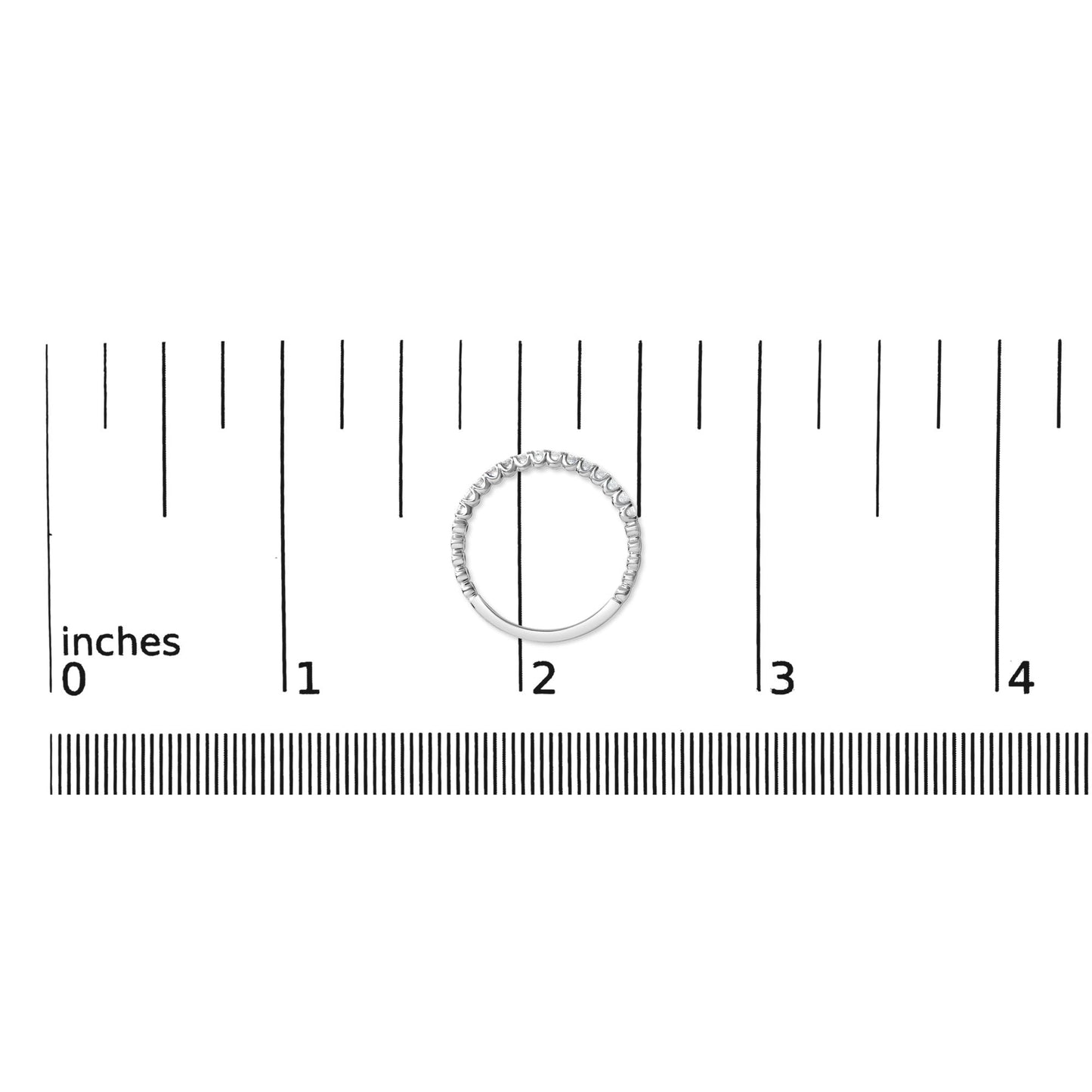 White metal ring with round white gemstones in prong settings along the upper half, shown from a top-down angle on a measurement scale.