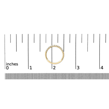 Yellow metal ring with round white gemstones in prong settings, shown flat on a scale with a top-down view.