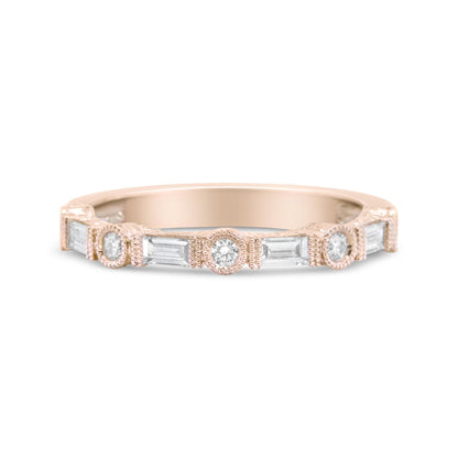 Front-facing view of a rose-colored ring featuring alternating bezel-set round white gemstones and invisibly-set baguette-shaped white gemstones.