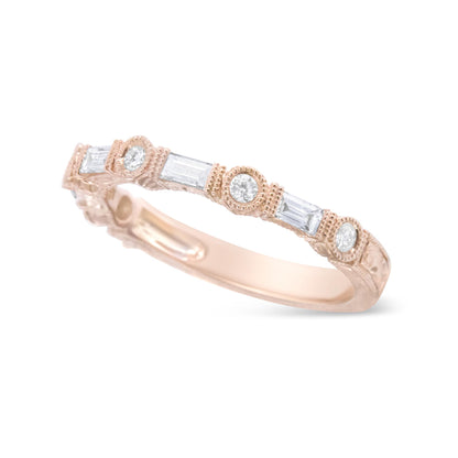 Rose metal ring with alternating bezel-set round white gemstones and invisibly set baguette white gemstones, shown at an angled close-up.