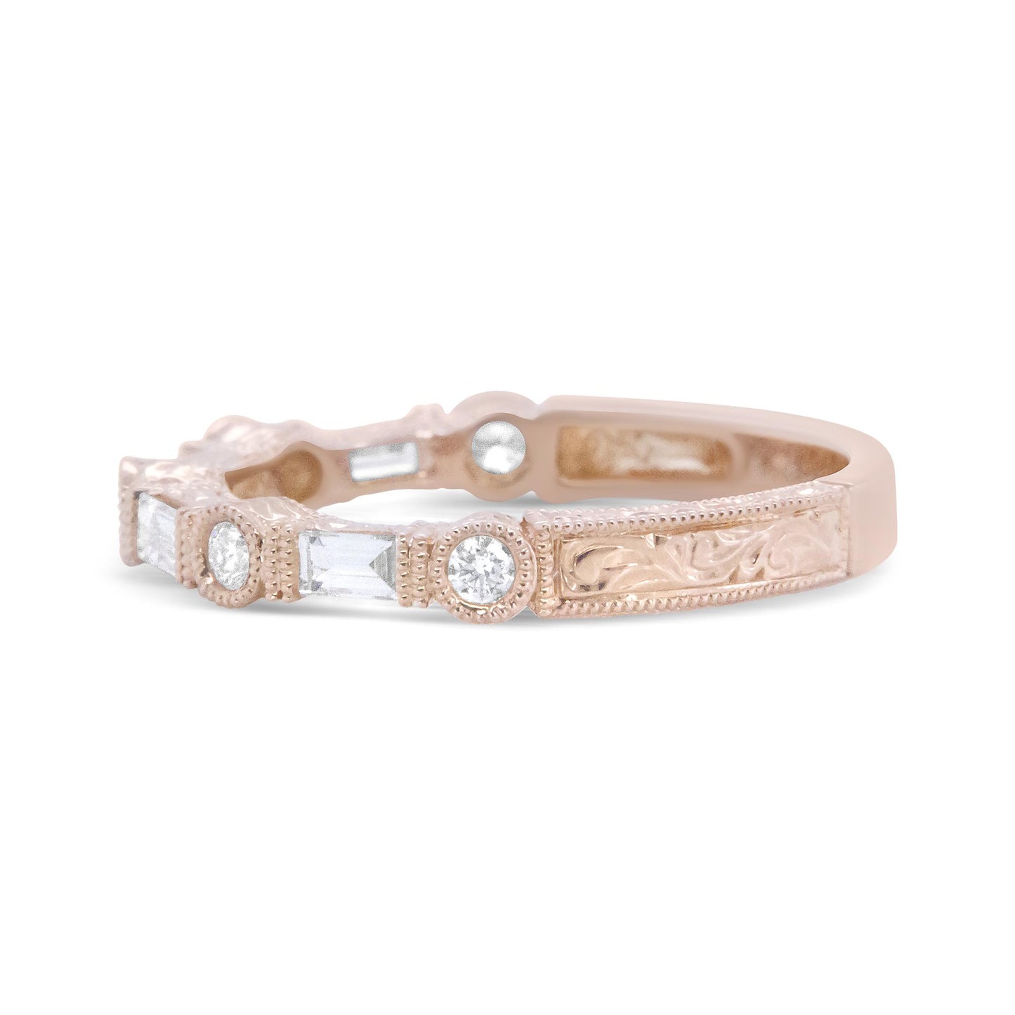 Close-up side angle of a rose-colored ring featuring white baguette-shaped gemstones with invisible settings and white round-shaped gemstones with bezel settings, showcasing intricate engraved details along the band.
