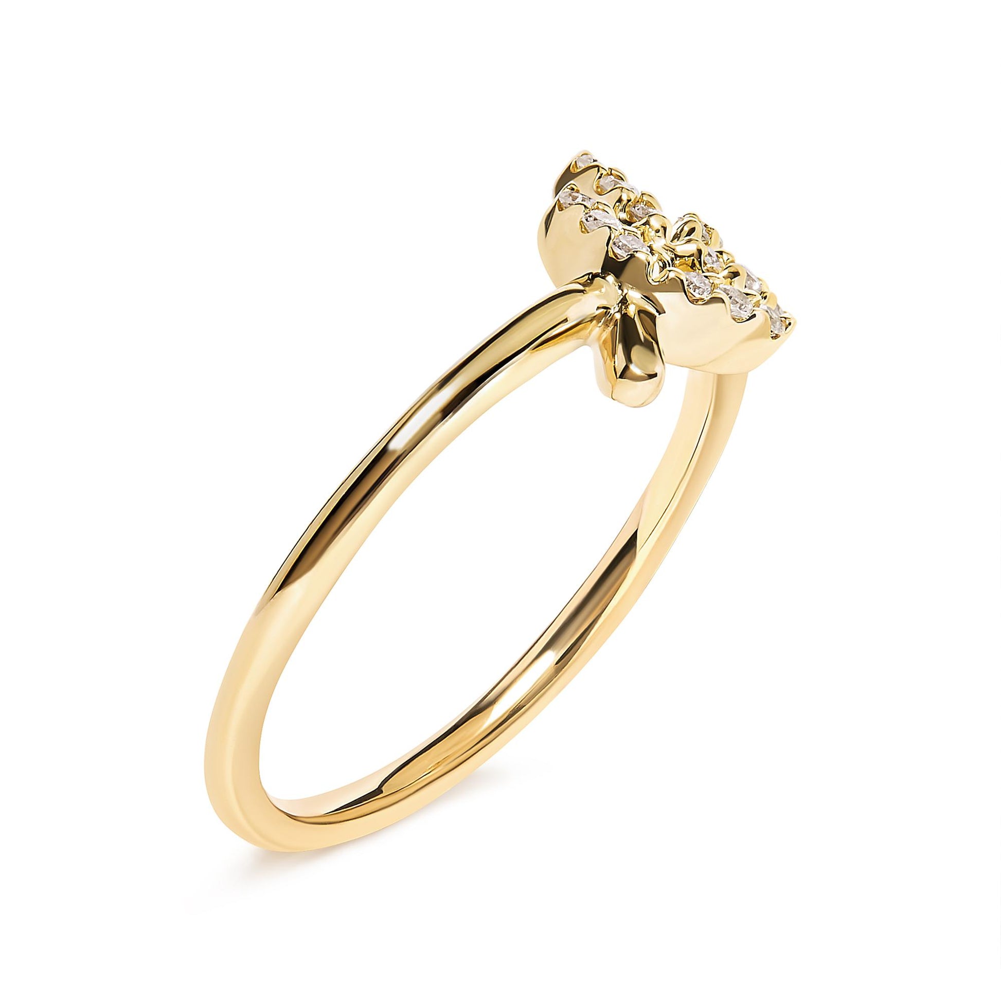 Yellow metal ring with a flower-shaped cluster of small white gemstones in pave setting, shown at a slight side angle.