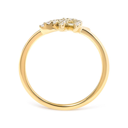 Close-up side view of a yellow metal ring with two clusters of round white gemstones in pave setting on top.