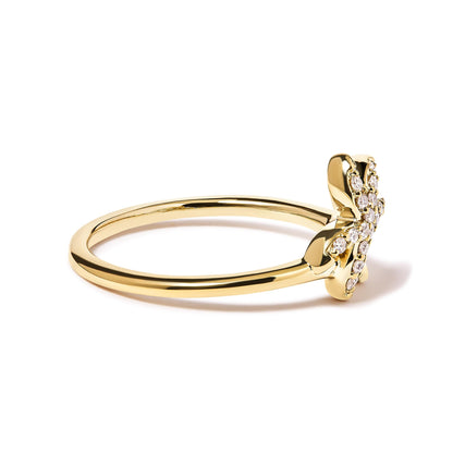 Side angle view of a yellow ring with a flower-shaped head adorned with white round gemstones in pave setting.