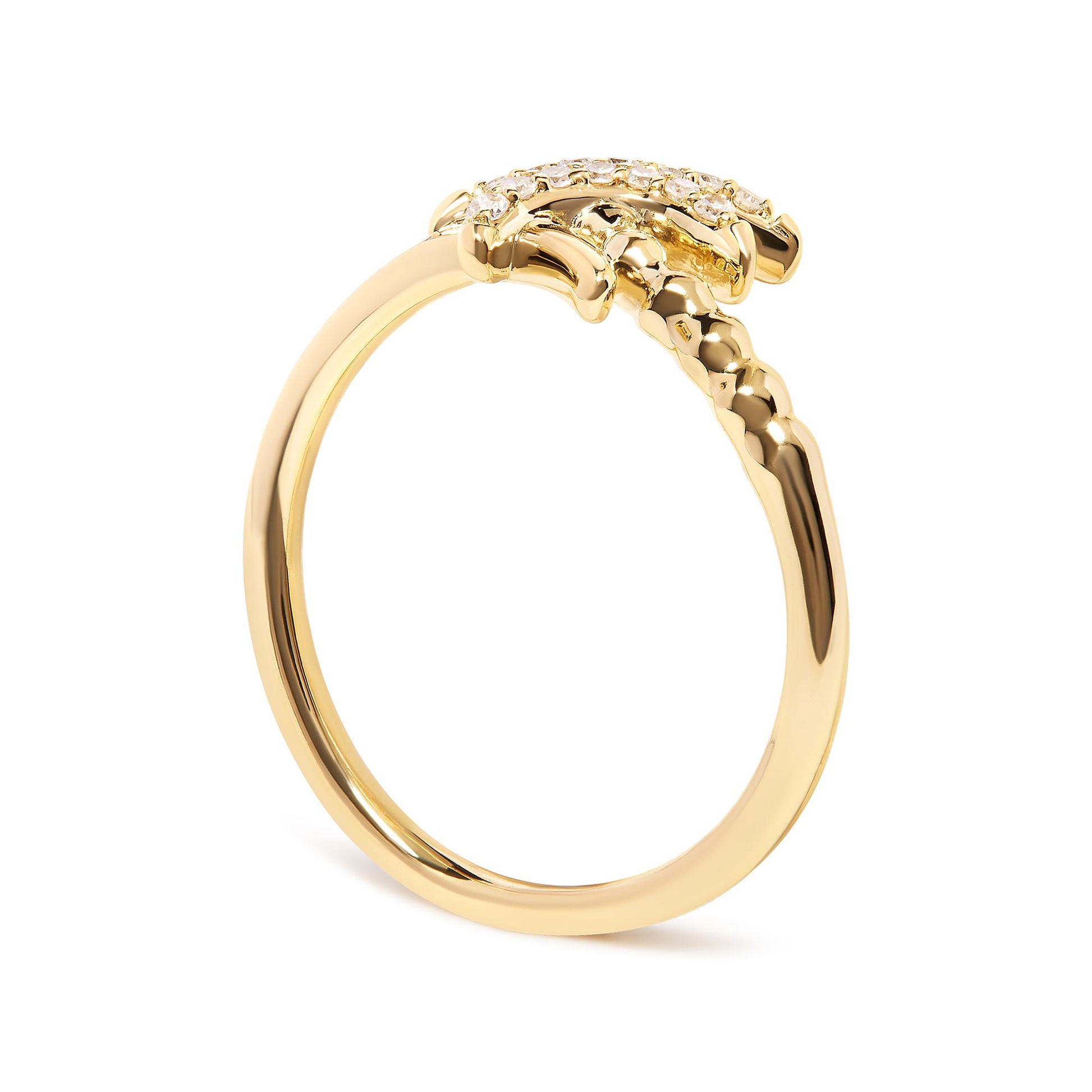 Side angle view of a yellow metal ring featuring a pave setting of round white gemstones on the top.