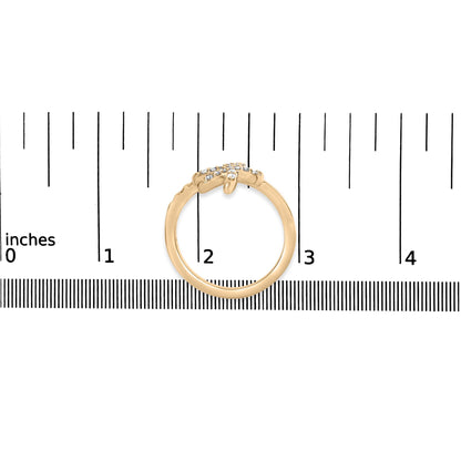 Yellow ring with pave set round white gemstones, shown from the front on a ruler for size reference.