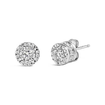 Close-up front and side view of round white metal stud earrings featuring central round white gemstones in four-prong settings, surrounded by two rows of smaller round white gemstones in shared prong and channel settings.