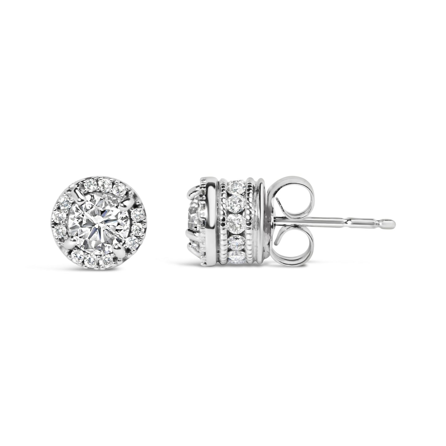 Close-up front and side view of a pair of white metal stud earrings featuring a central round gemstone in a four-prong setting surrounded by a halo of smaller round gemstones with additional rows of round gemstones in shared prong and channel settings on the sides.