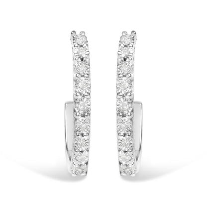 Front-facing close-up of white metal hoop earrings with round white gemstones set along the outer edge in a miracle setting.