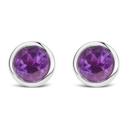 Front view of a pair of white metal stud earrings each featuring a round purple gemstone in a bezel setting.