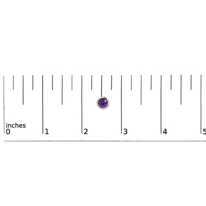 Close-up top view of a single round purple gemstone earring with a white metal bezel setting, shown on a ruler scale.