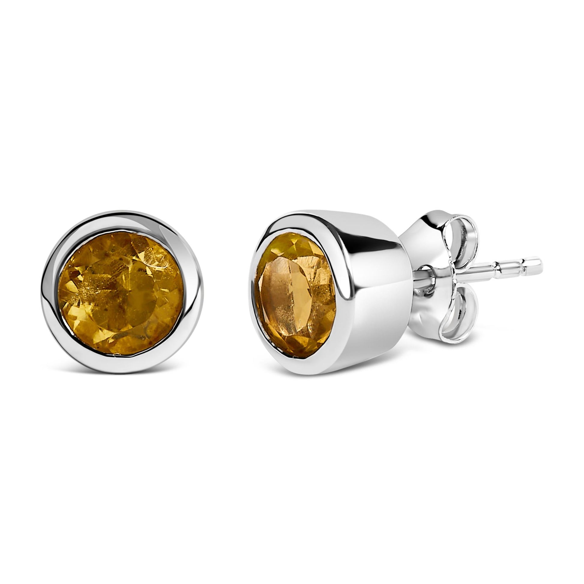 Close-up front and side angle of a pair of white metal stud earrings, each set with a round yellow gemstone in a bezel setting.
