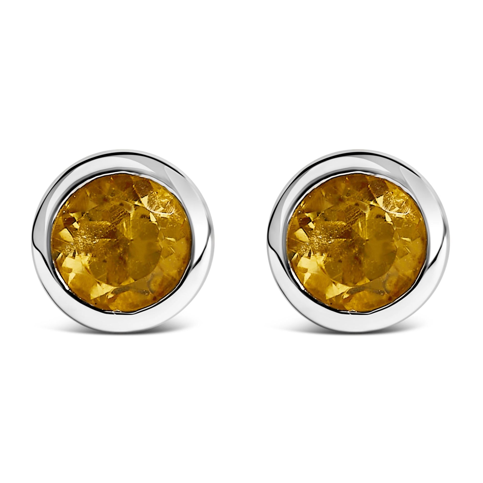 Front view of a pair of white metal round stud earrings with bezel-set yellow round gemstones.