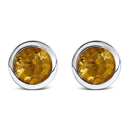 Front view of a pair of white metal round stud earrings with bezel-set yellow round gemstones.