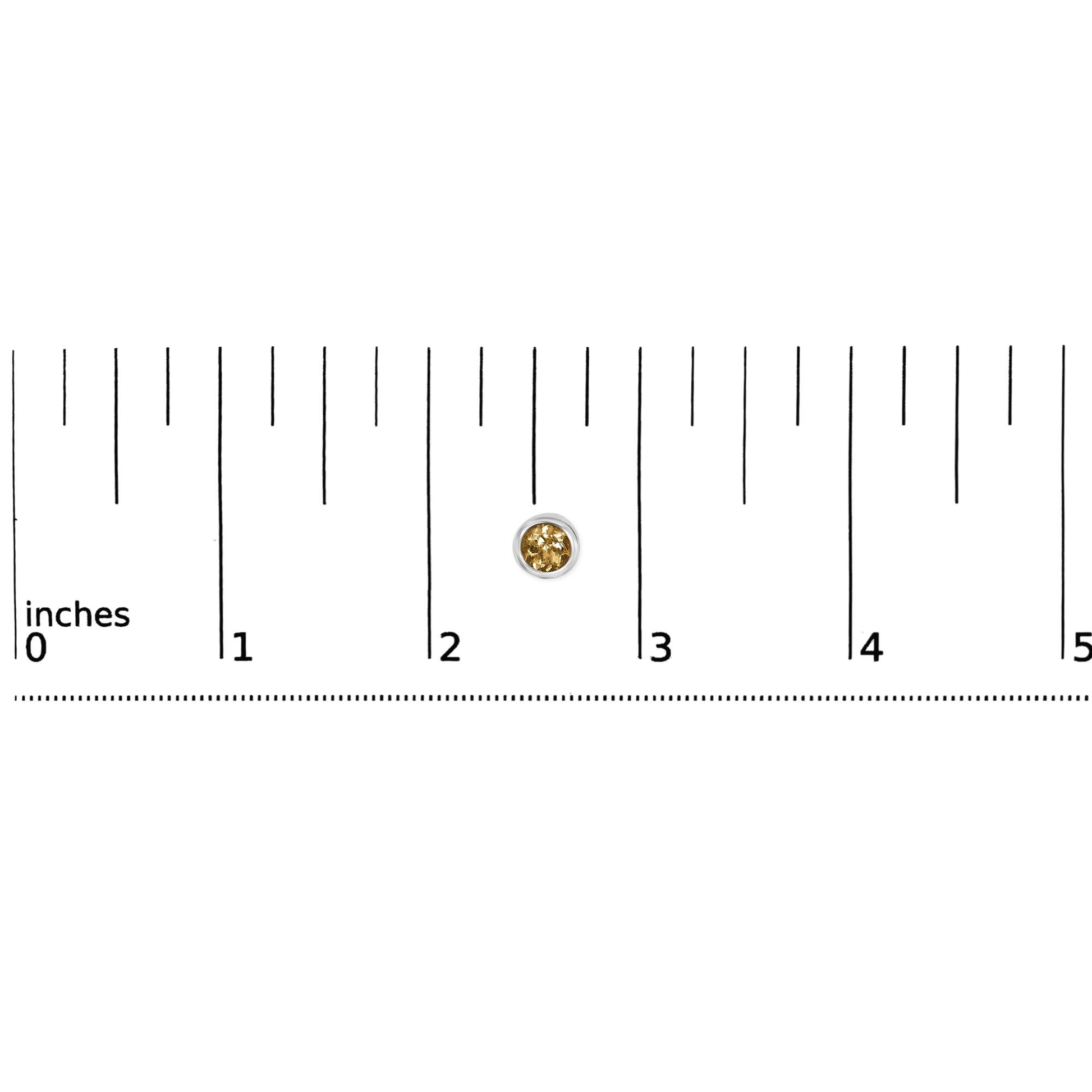 Single white metal earring with round yellow gemstone in bezel setting, shown on a ruler scale, front-facing angle.