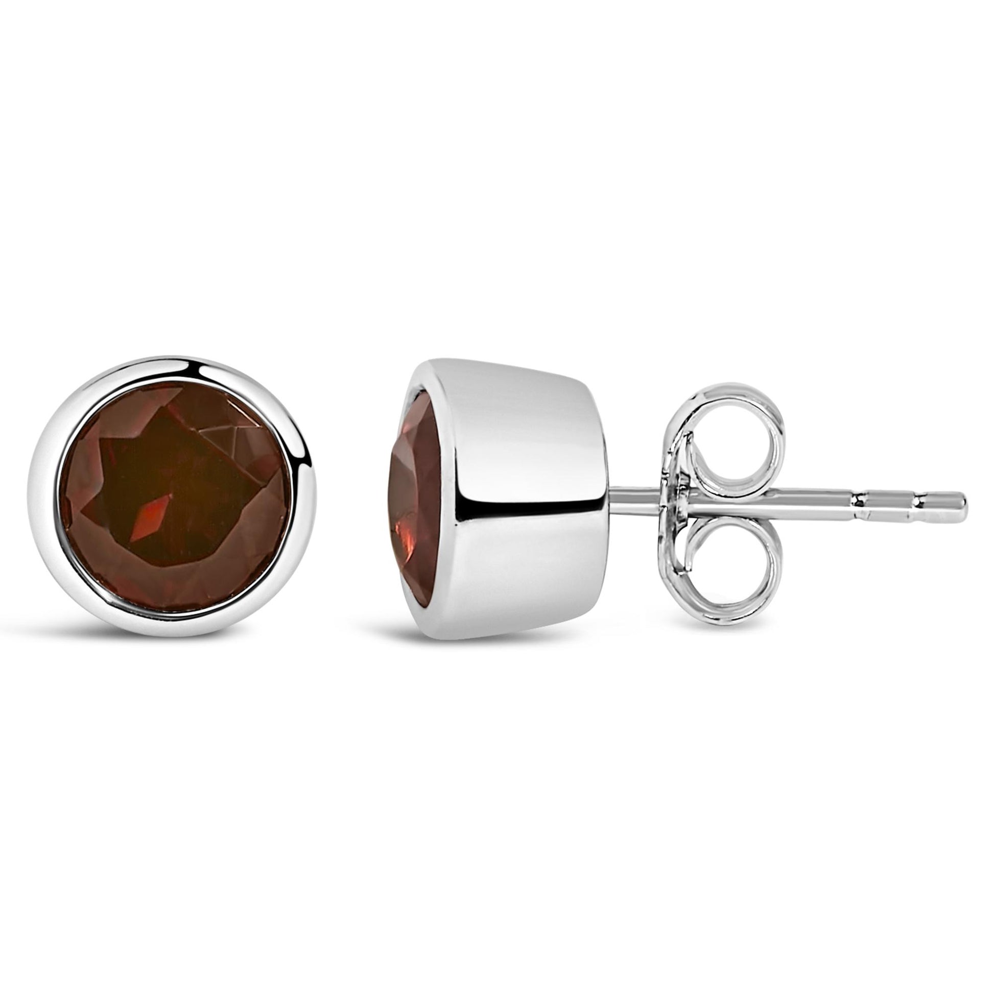 Pair of round white stud earrings with red gemstones in bezel settings, shown from front and side angles on a white background.
