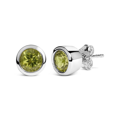 Pair of white metal stud earrings with round green gemstones in bezel settings, shown from a front and side angle on a white background.