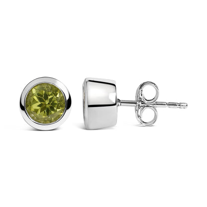 Pair of white metal stud earrings with round green gemstones in bezel settings, shown in a front and side view on a white background.