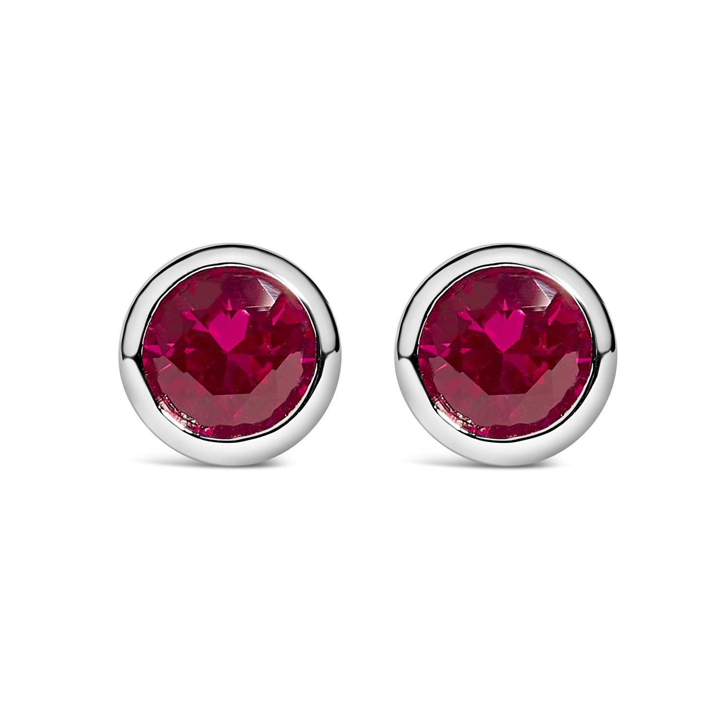 Front view of a pair of round white metal stud earrings with bezel-set red gemstones.