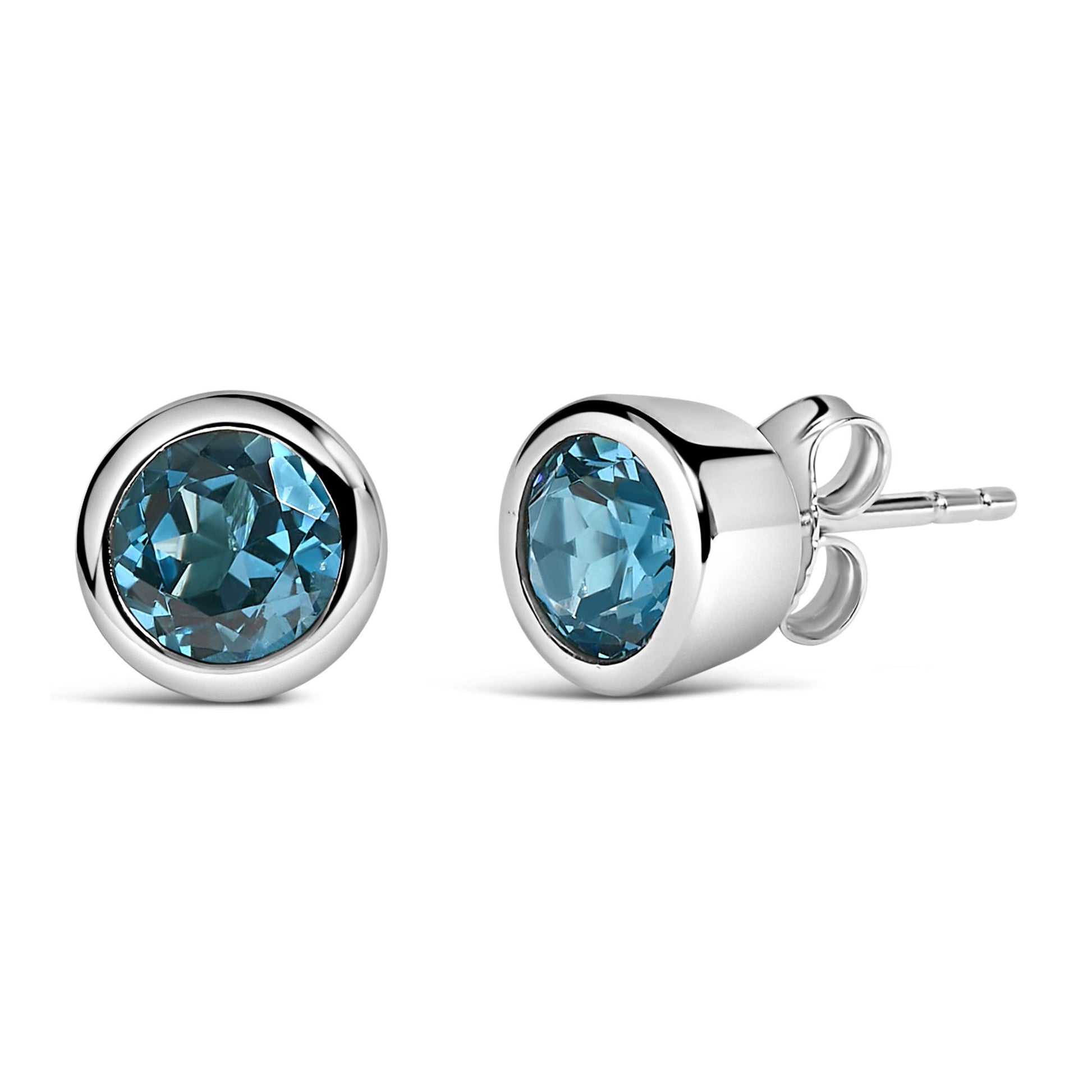 Pair of white metal stud earrings with round blue gemstones in bezel settings, shown from a side and front angle on a white background.