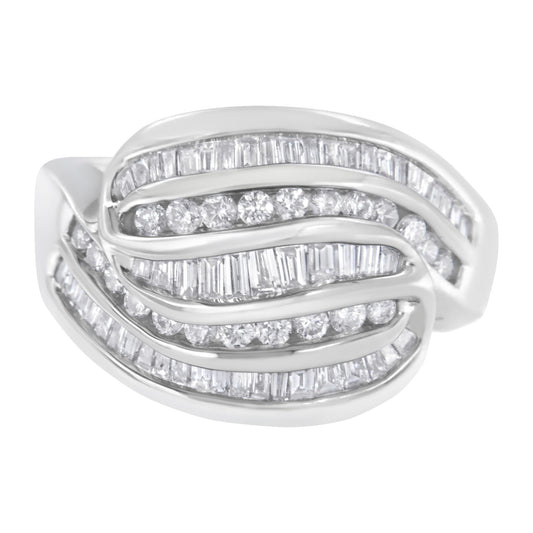 White metal ring with overlapping curved rows set with channel-set round and baguette white gemstones, shown in a close-up front angle.