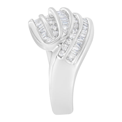 White metal ring with alternating rows of round and baguette channel-set white gemstones, shown from a side angle.