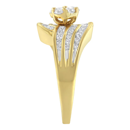 Yellow metal ring with a cluster of round white gemstones in a raised prong setting, accompanied by three rows of channel-set round white gemstones, shown in a front-facing angle.